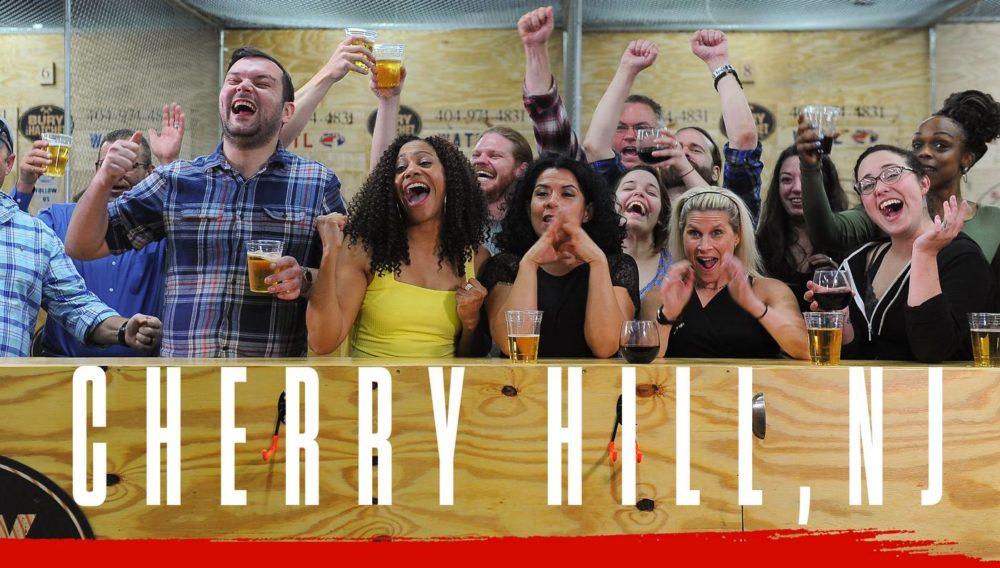 Bury The Hatchet Cherry Hill NJ City Page Header Image. Axe throwers celebrating with hands in air